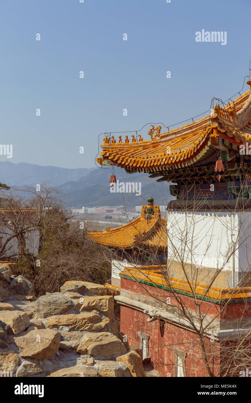 Buddhist temple buildings perched in rocky hillside at the Summer Palace in Beijing, China. Stock Photo