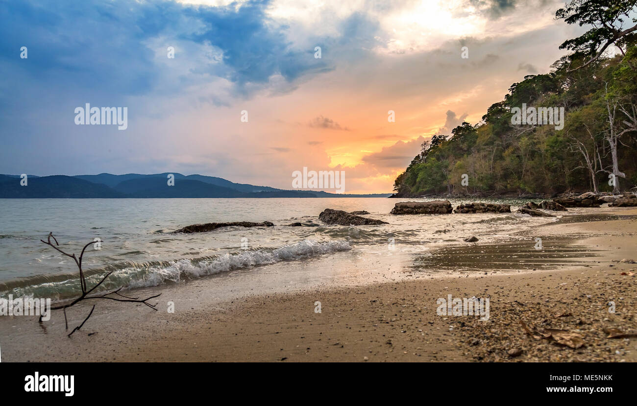 Scenic beach sunset at Chidiya Tapu, Port Blair, Andaman India with view of the sea shore and distant cliffs. Stock Photo