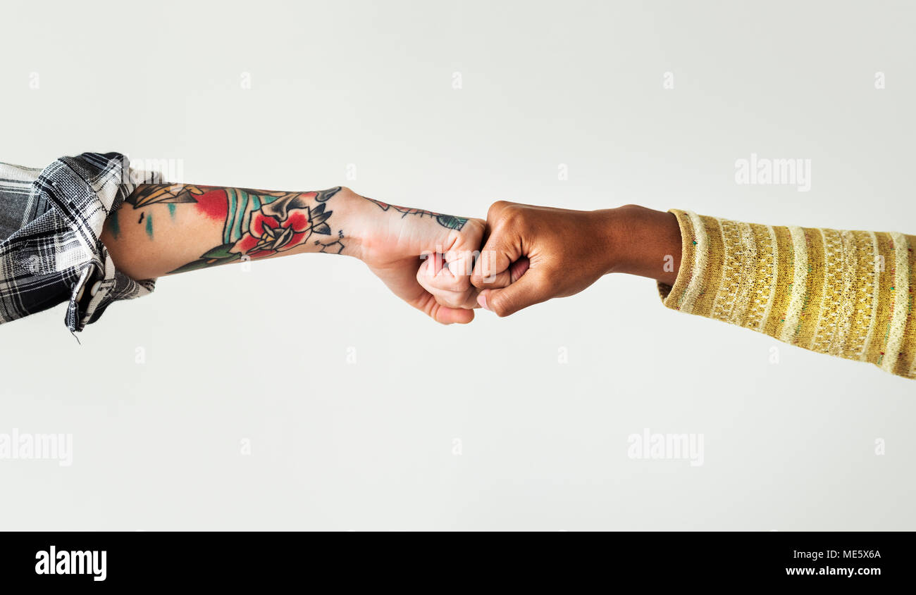 People bumping their fists together Stock Photo - Alamy
