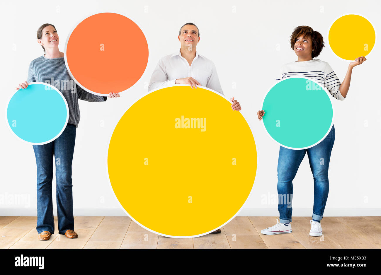 Diverse people holding colorful circles Stock Photo