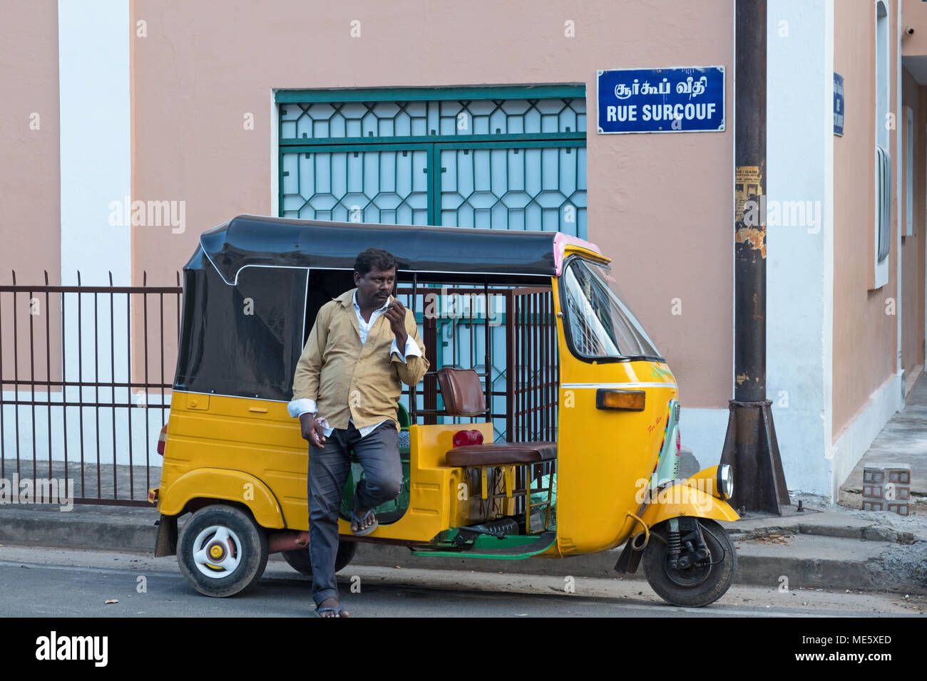 Pondicherry, India - March 16, 2018: Unidentified auto rickshaw driver awaiting custom in the traditional French quarter Stock Photo