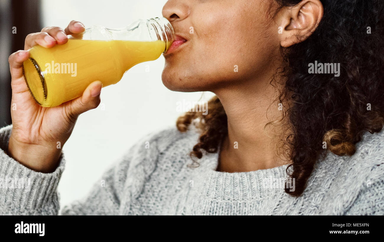 Woman drinking fresh orange juice Stock Photo