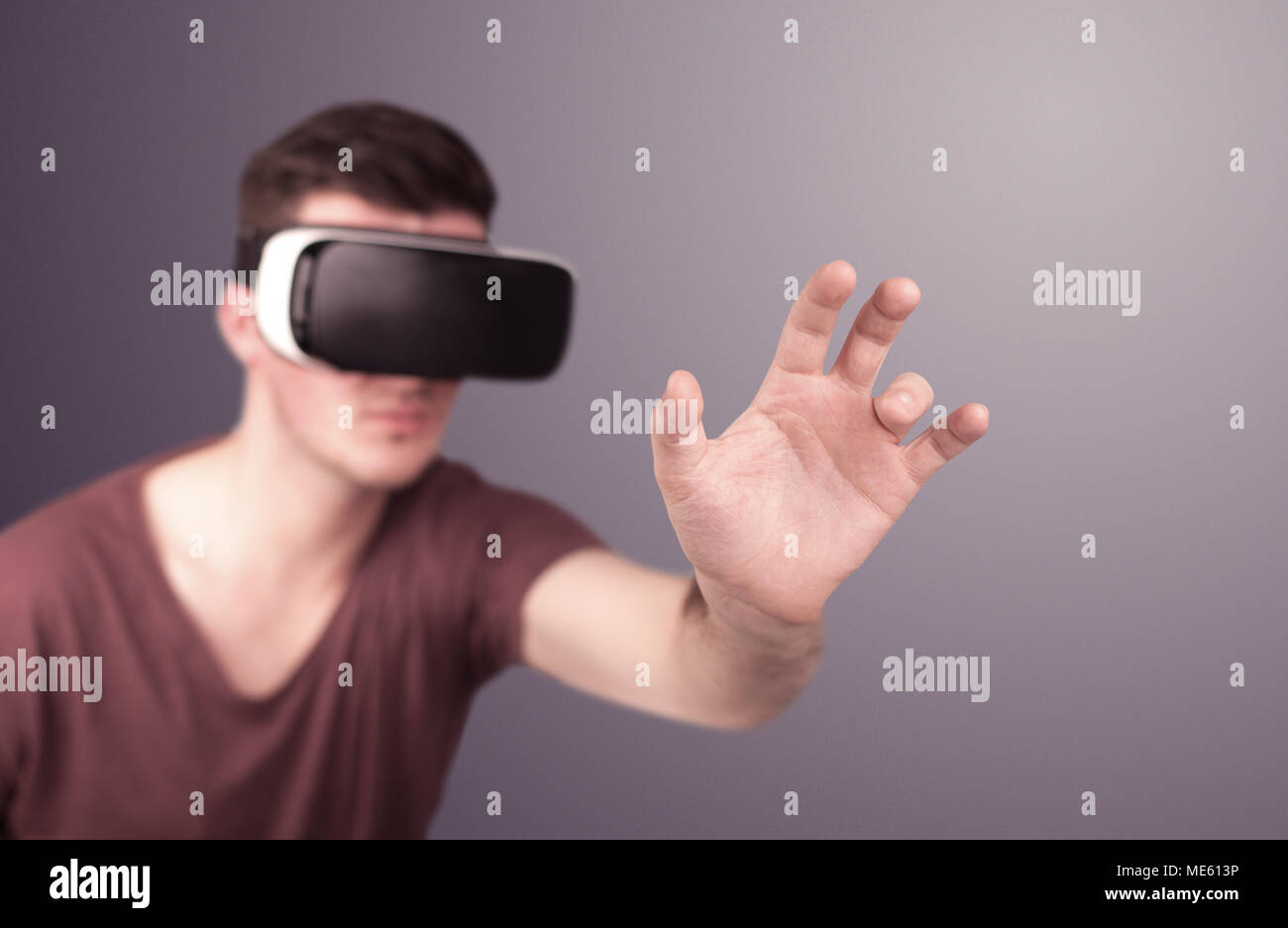 Young impressed man wearing virtual reality goggles Stock Photo - Alamy