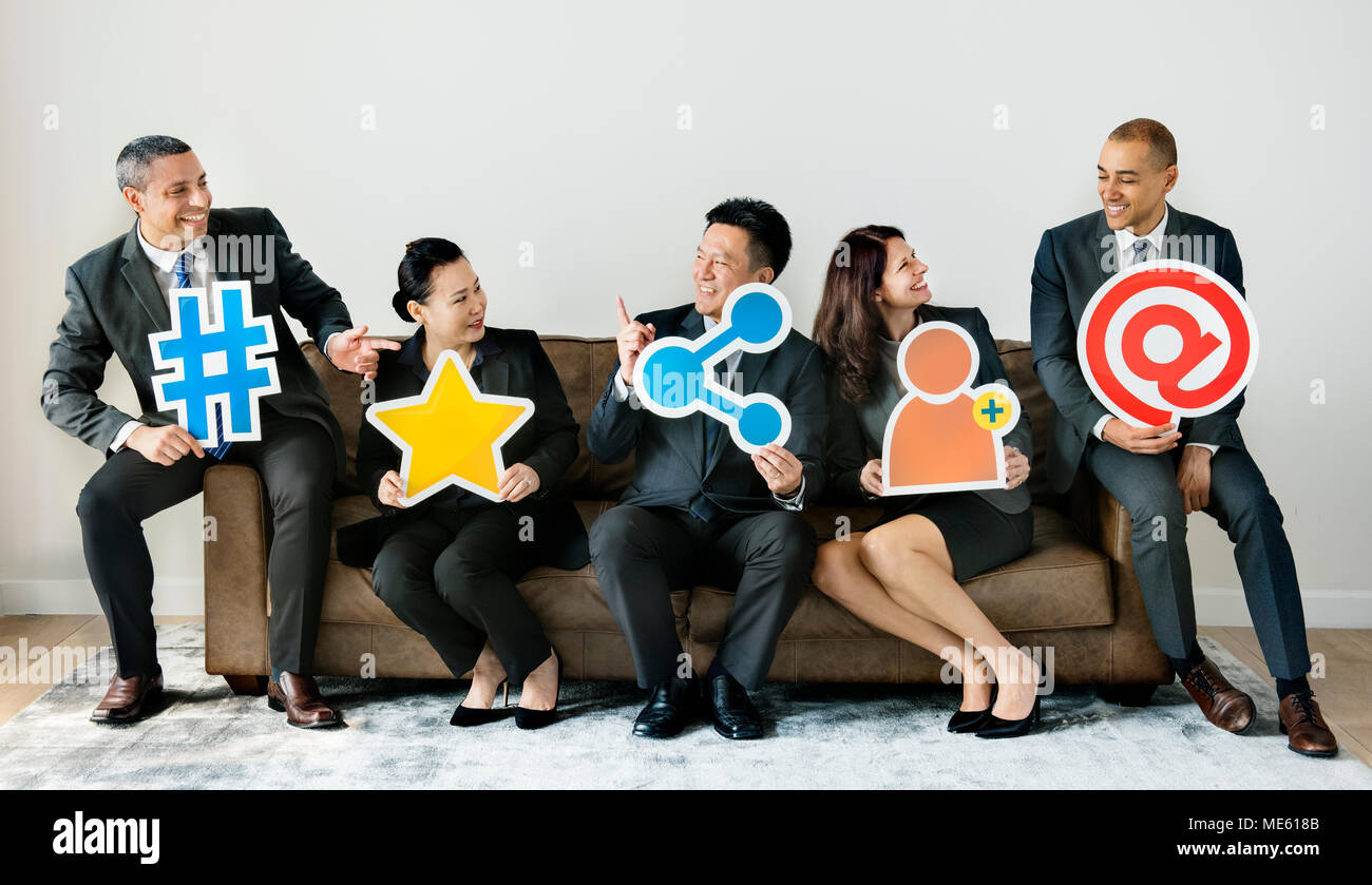 Business people sitting together with icons Stock Photo