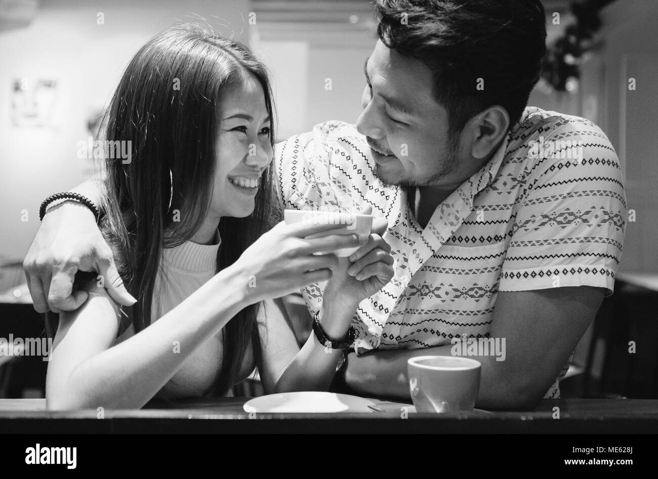 Lovely asian couple having coffee Stock Photo