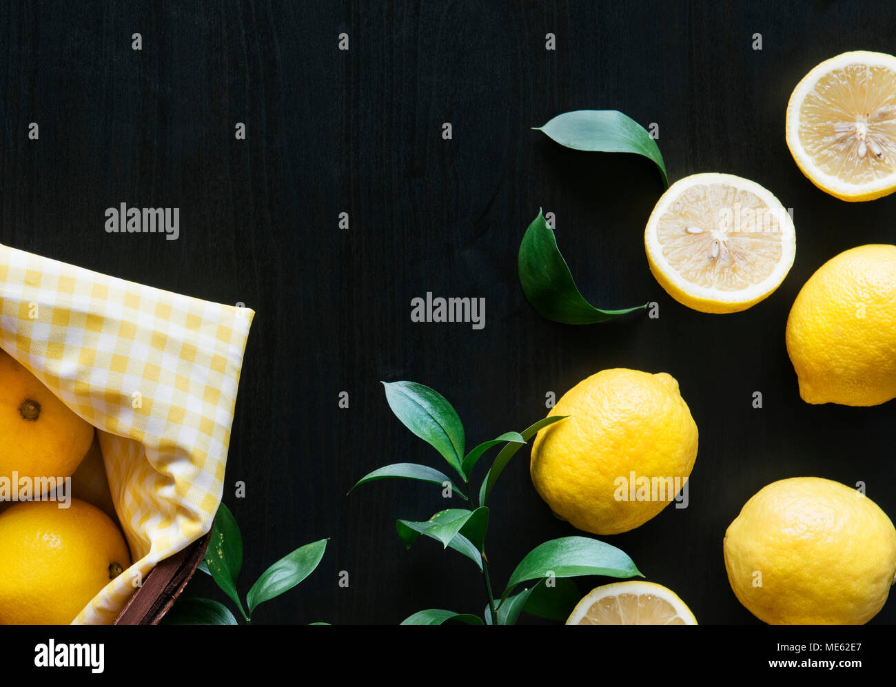 Fresh yellow lemons on black background Stock Photo