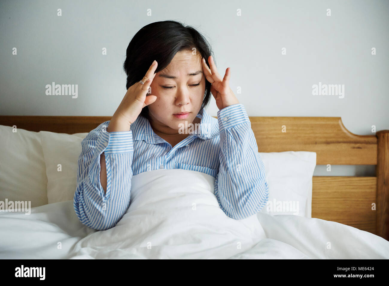 A woman waking up with headache Stock Photo