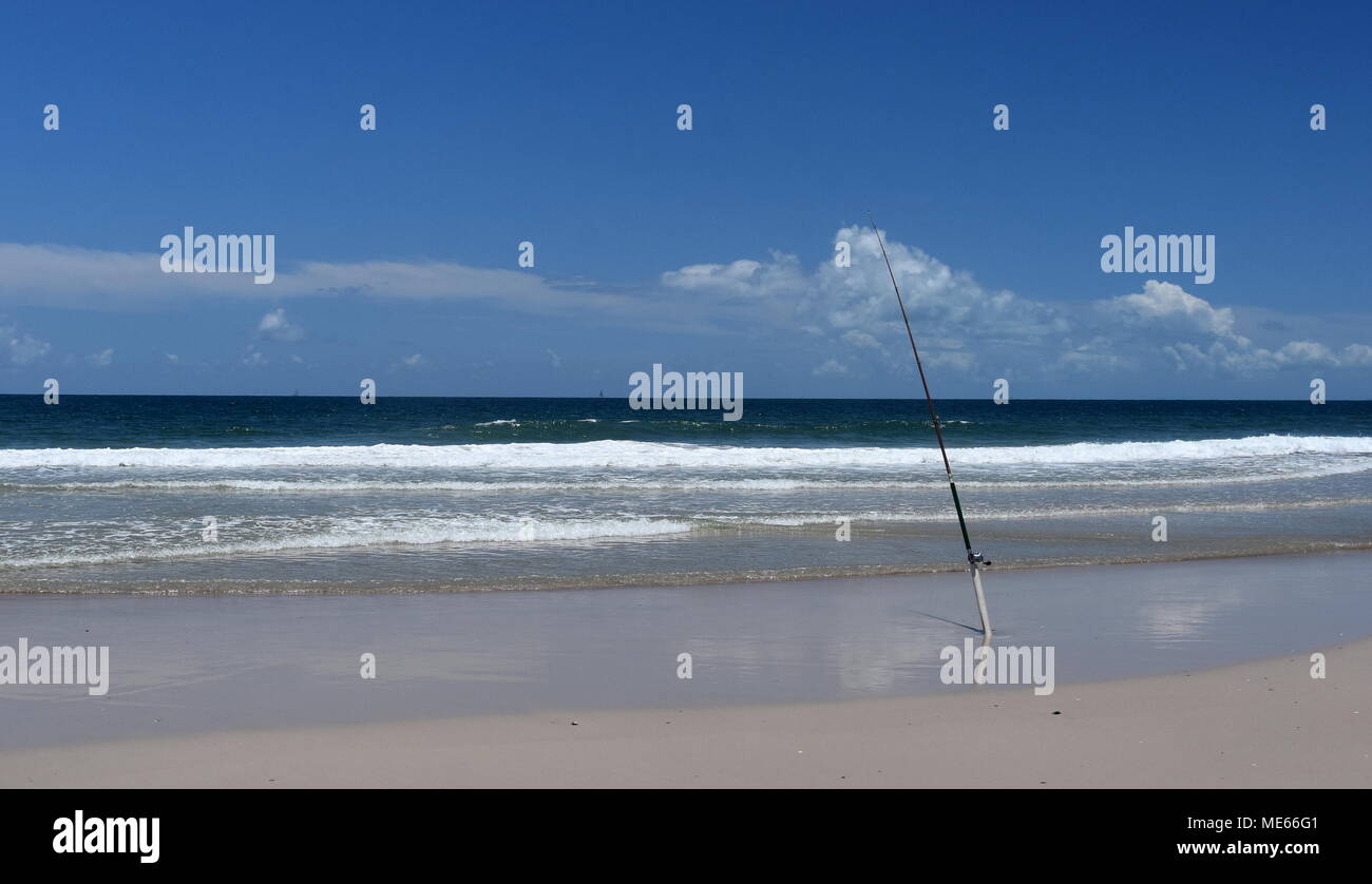 Premium Photo  Fishing rods stand on the sandy beach Fixed fishing rod set  up on a beach near the surf on the incoming tide. Blue sky with clouds,  turquoise sea.
