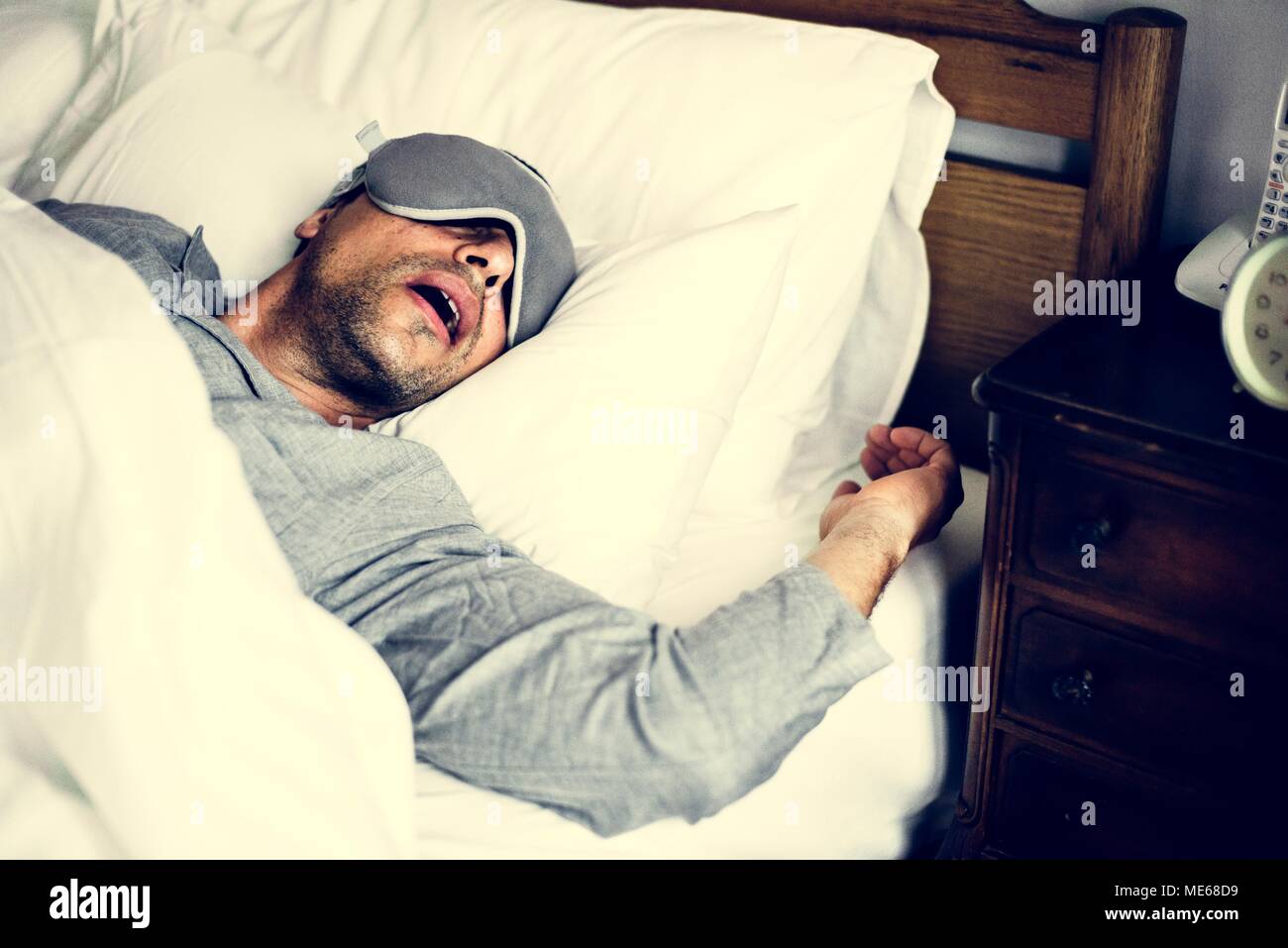 A man sleeping on a bed Stock Photo
