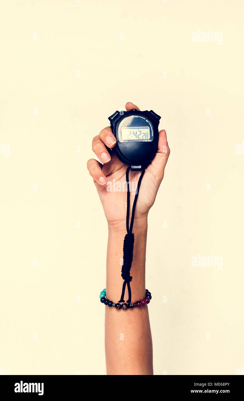 Measuring The Running Speed Of An Athlete Using A Mechanical Stopwatch.  Hand With A Stopwatch On The Background Of The Legs Of A Runner. Stock  Photo, Picture and Royalty Free Image. Image