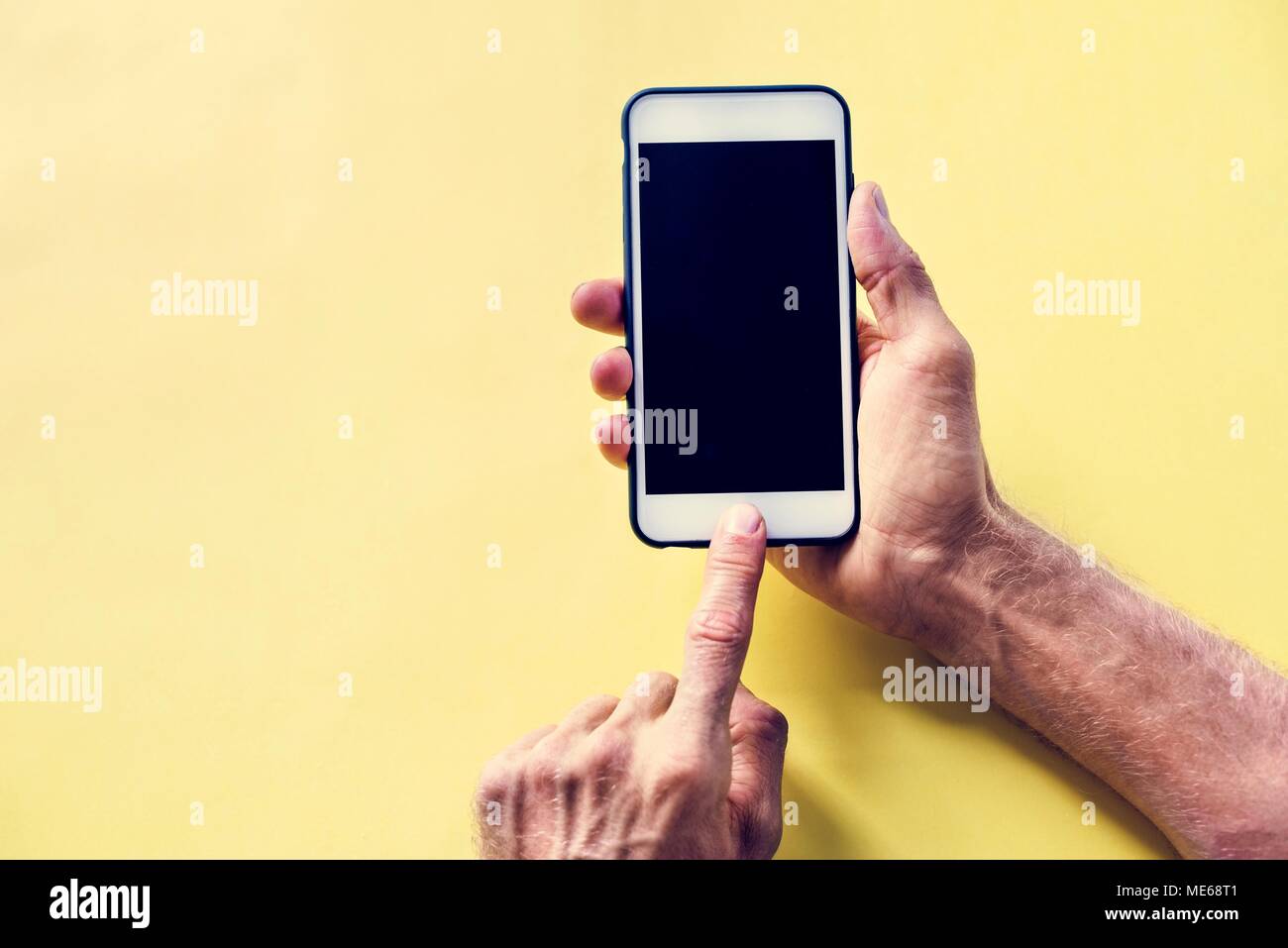 Hands holding smartphone isolated on a background Stock Photo