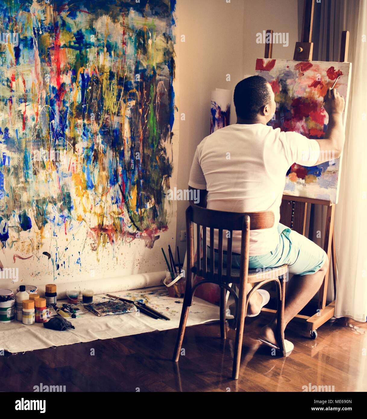 Black artist man doing his art work Stock Photo