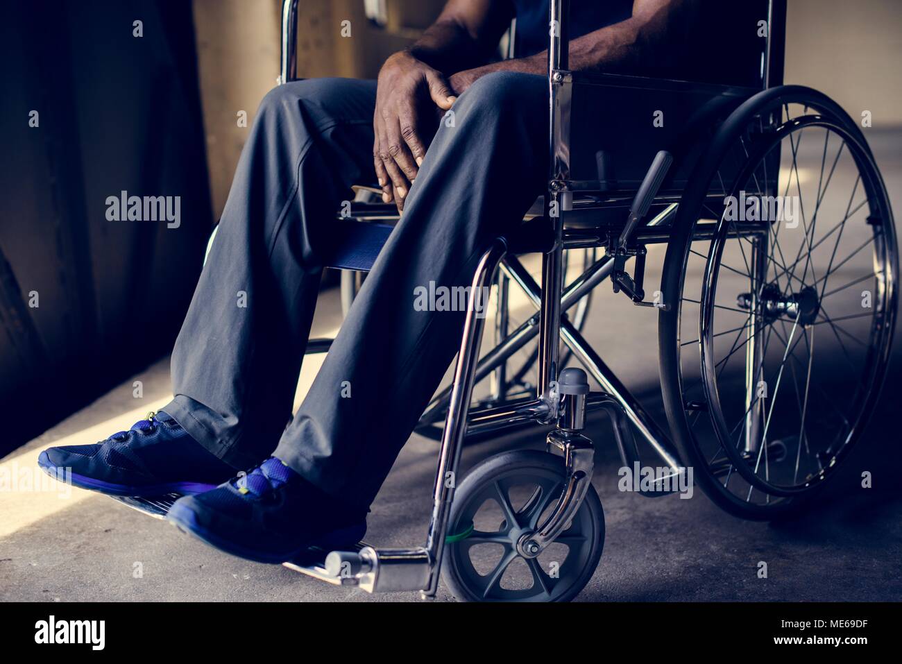 Disabled african man sitting on the wheelchair Stock Photo
