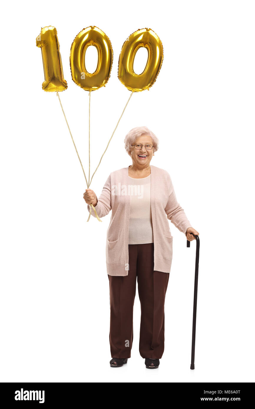 Full length portrait of an elderly woman with a golden number hundred balloon and a cane isolated on white background Stock Photo