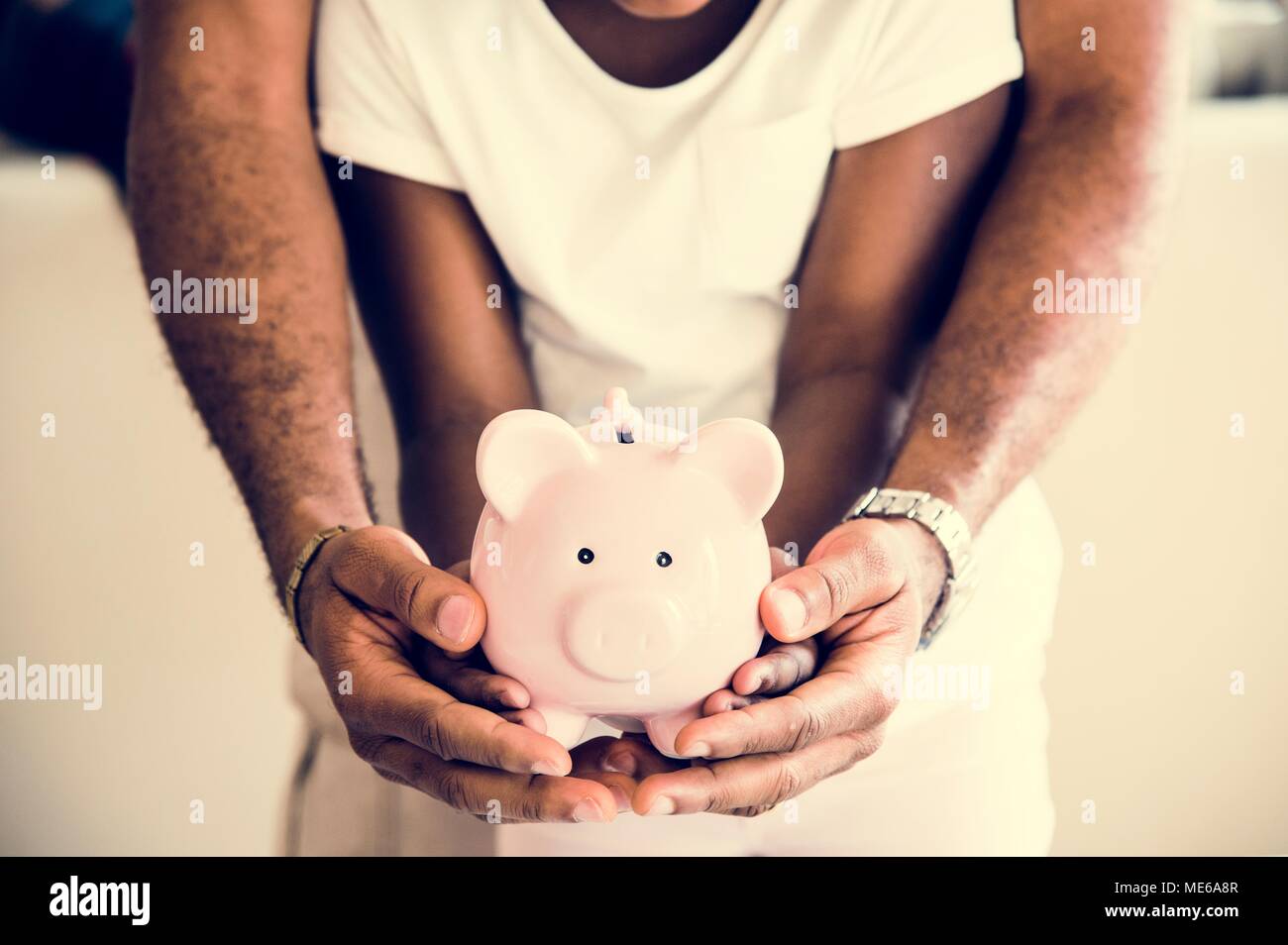 Dad and daughter holding piggy bank on hands Stock Photo - Alamy