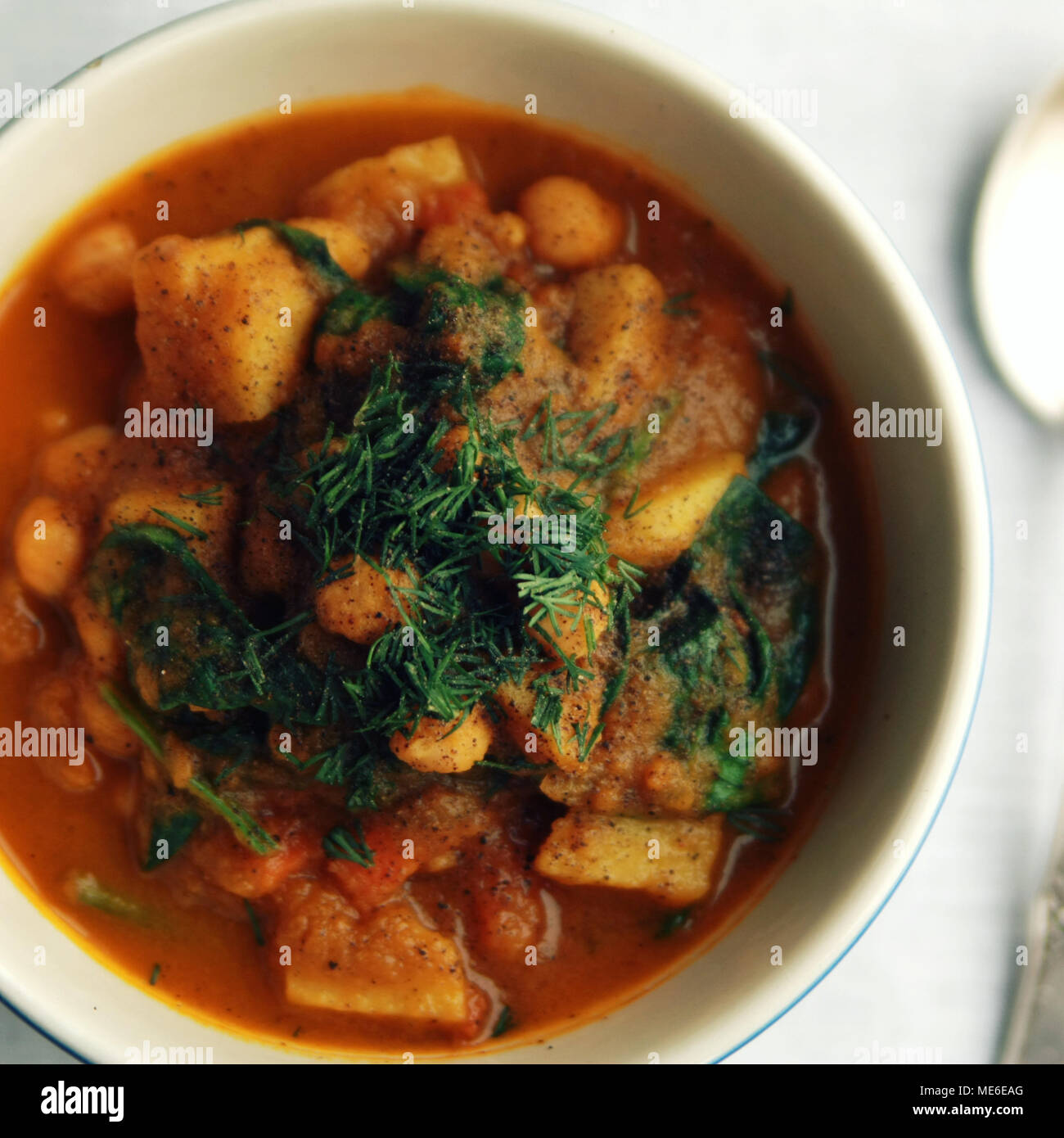 Simple vegetable soup. European cuisine. Chickpeas, potato and carrot. Organic food. Vegan dish. Vegetarian lunch. Top view. Toned photo. Stock Photo