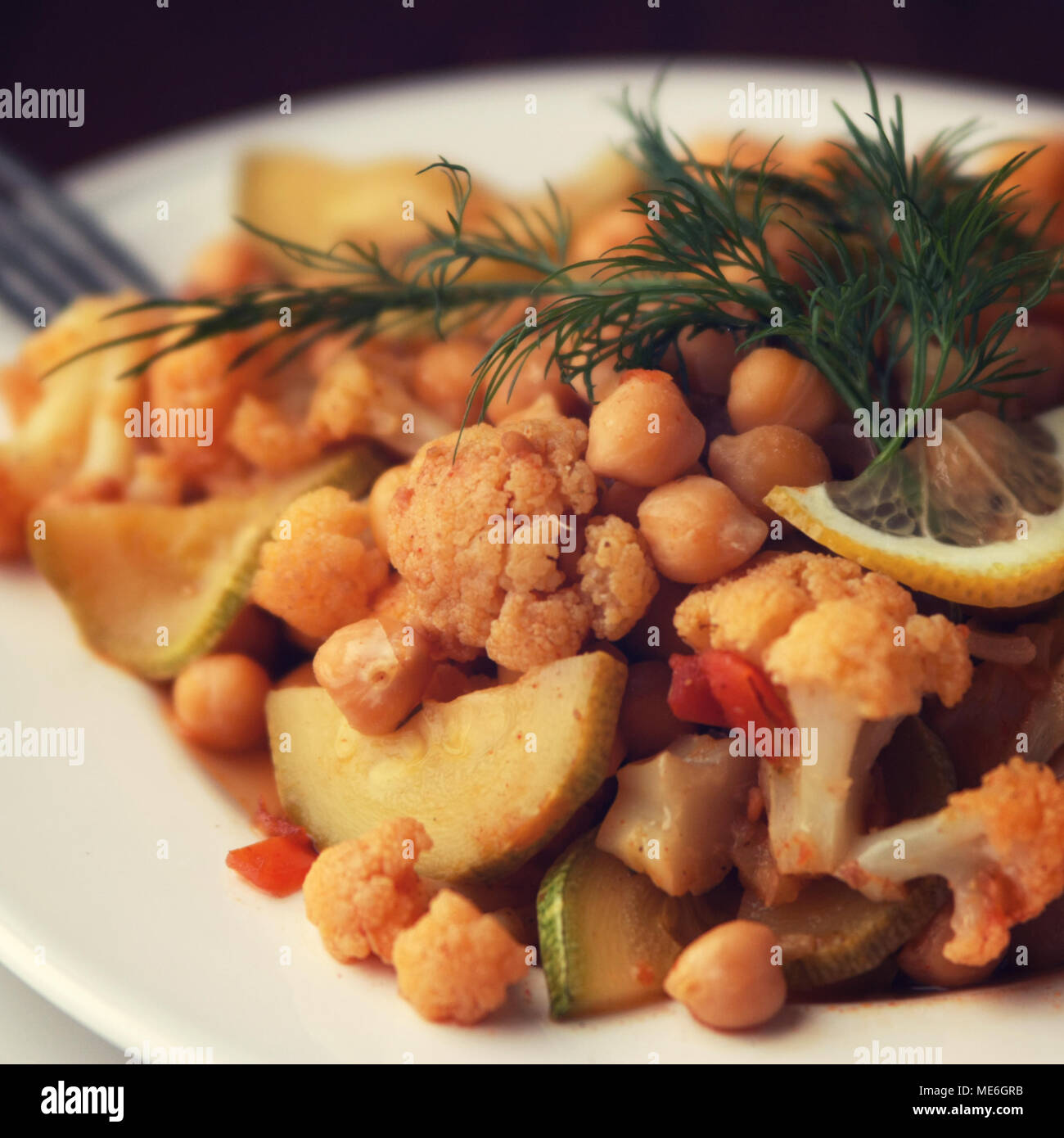 Vegetable stew with chickpeas, cauliflower and cabbages. Organic food. Vegan dish. European cuisine. Vegetarian lunch. Toned photo. Close up. Stock Photo