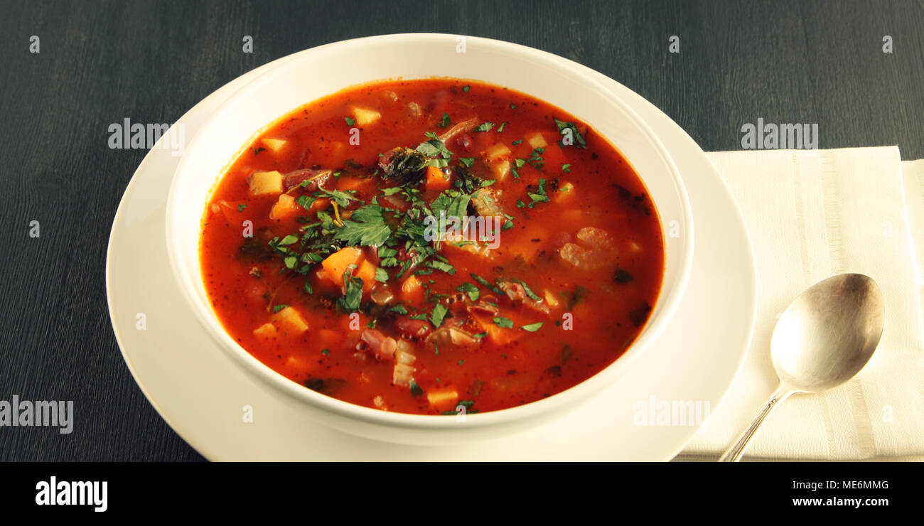Tomato soup with red beans, potato and carrot. Vegan diet. European cuisine. Vegetarian dish. Main course. Organic meal. Wide photo. Stock Photo