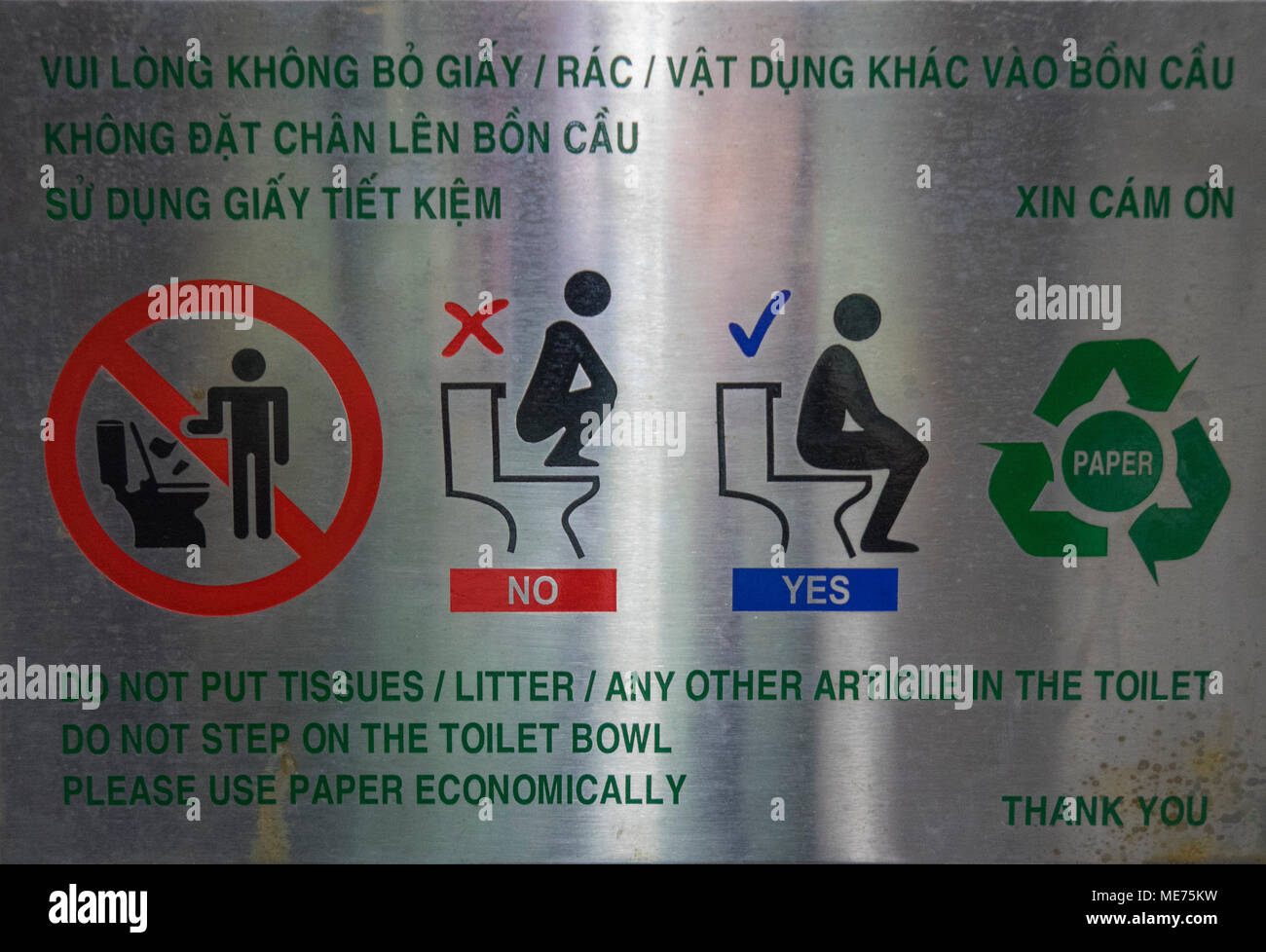 A metal sign with instructions on the proper use of a toilet in Ho Chi Min City, Vietnam. Stock Photo