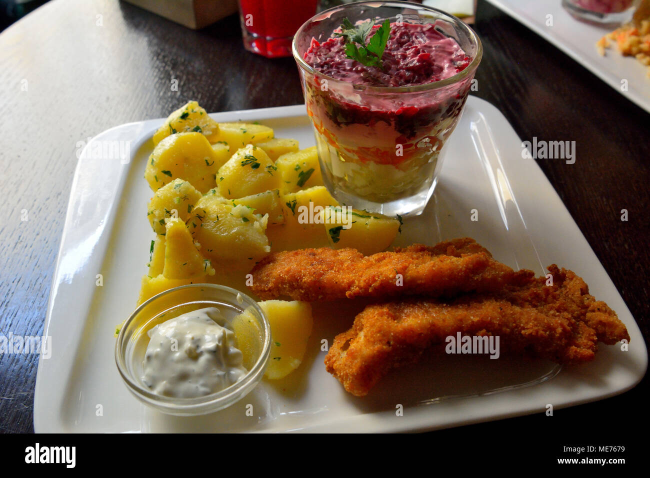Plate of fish and chips and Russian dressed herring salad. Stock Photo