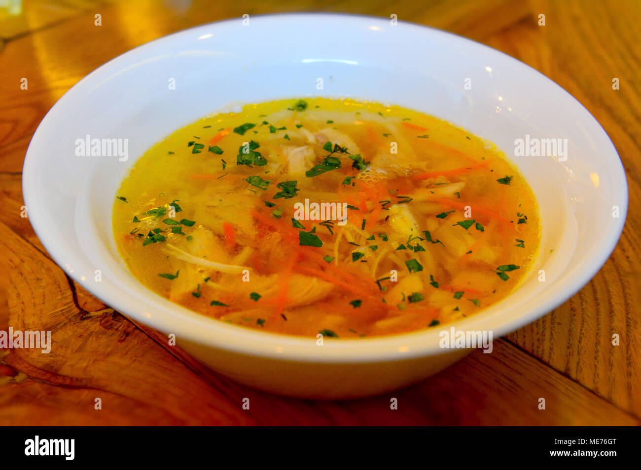 Plate of chicken noodle soup on the table. Stock Photo