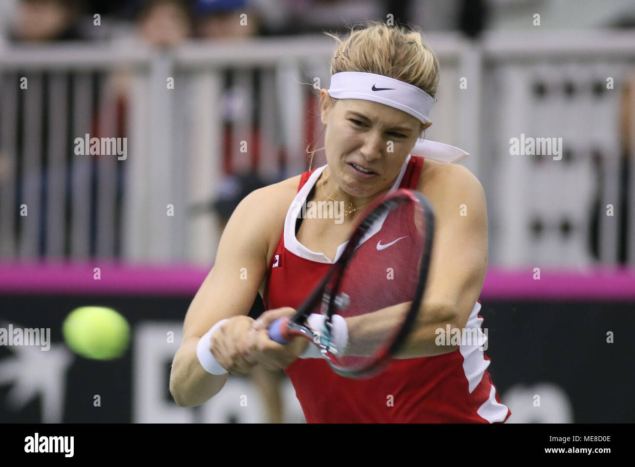 Montreal, Canada, 21 April 2018. Eugenie Bouchard of Canada hits a return against Kateryna Bondarenko of the Ukraine during their Fed Cup World Group II play-off tennis match in Montreal, Quebec, Canada on Saturday, April 21, 2018. Credit: Dario Ayala/Alamy Live News Stock Photo