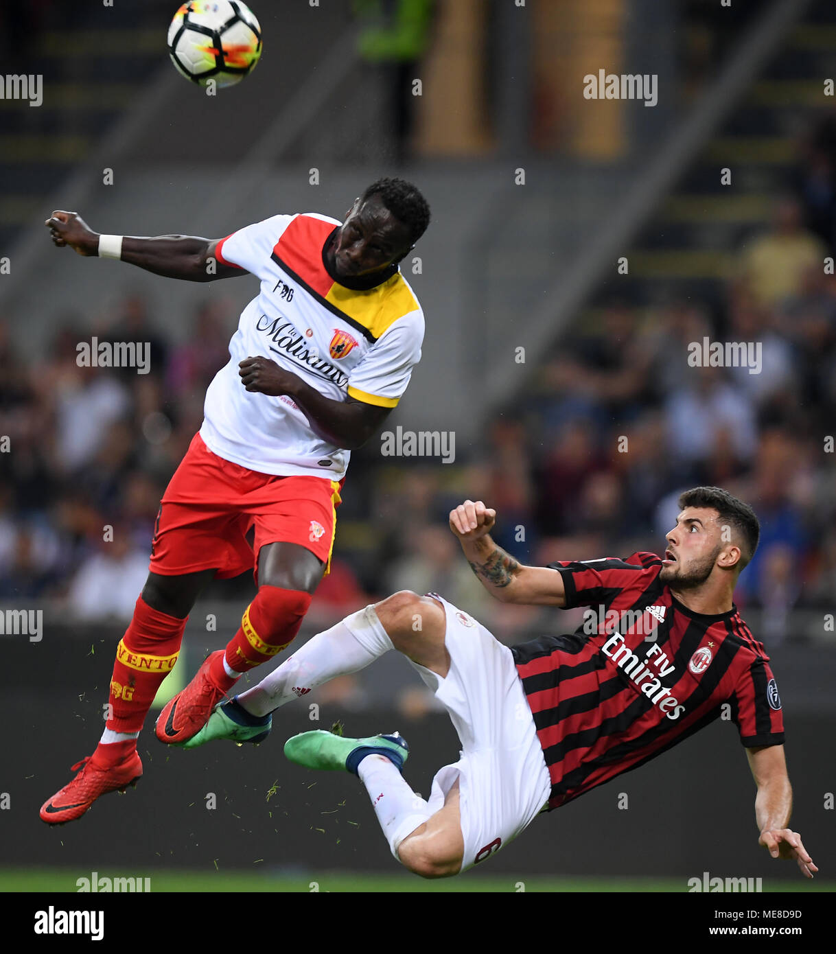 Milan, Italy. 21st Apr, 2018. Benevento's Bacary Sagna (L) vies with AC Milan's Patrick Cutrone during the Serie A soccer match between AC Milan and Benevento in Milan, Italy, on April 21, 2018. Benevento won 1-0. Credit: Alberto Lingria/Xinhua/Alamy Live News Stock Photo