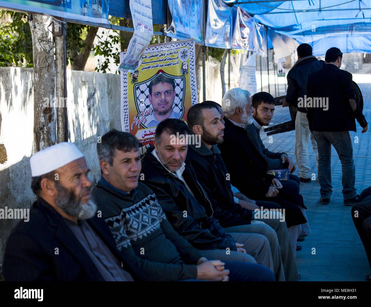 Gaza City, Palestine, April 22, 2018. Palestinians gather in mourning  outside the family home of 35-year-old professor and Hamas member Fadi  Mohammad al-Batsh, who was killed early in the day in Malaysia,