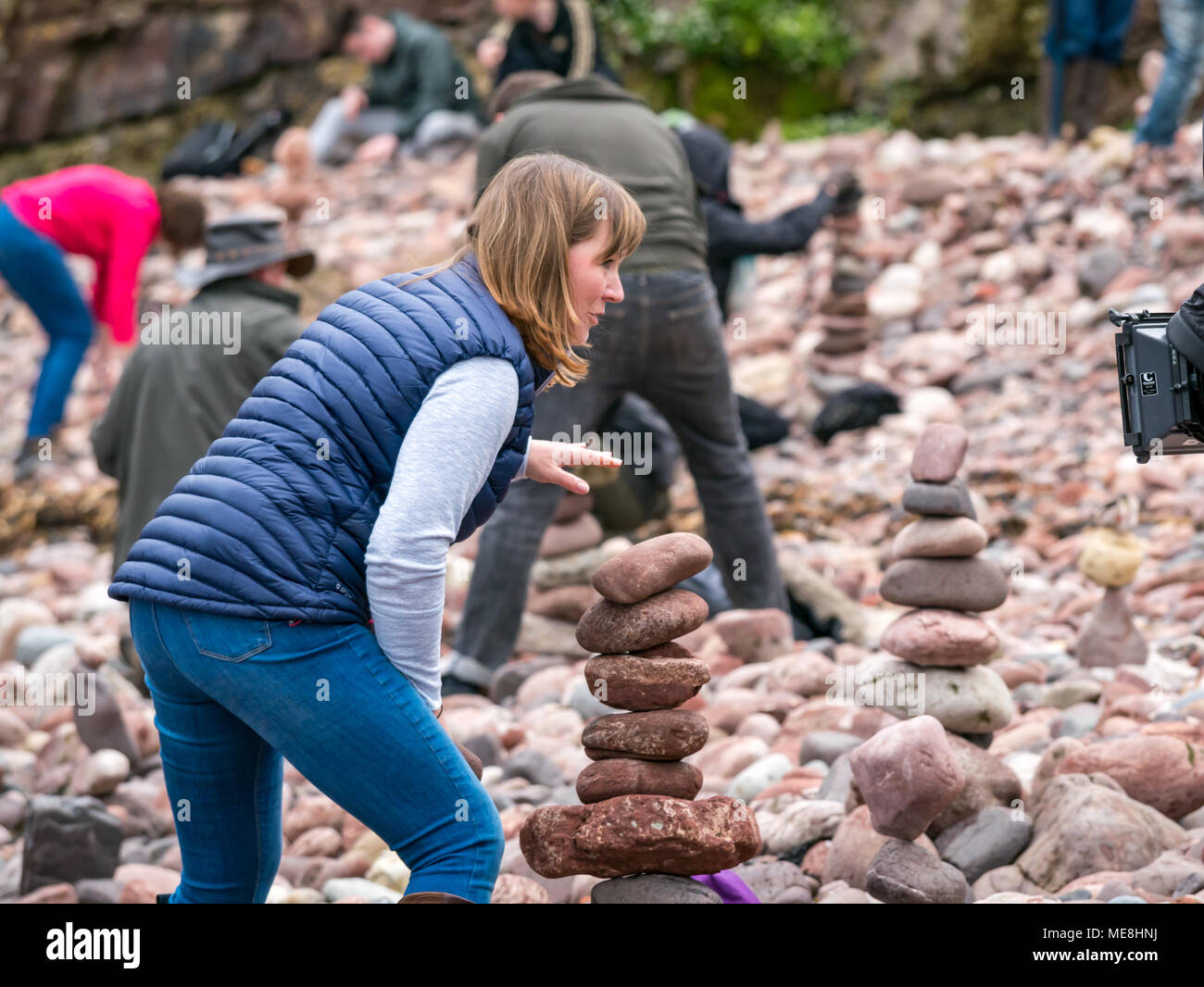 Dunbar, Scotland, 22 April 2018. Eye Cave Beach, Dunbar, East Lothian, Scotland, United Kingdom, 22nd April 2018. The second day of the Second European stone stacking championships took place this weekend in Dunbar, organised by Dunbar Street Art Trail. The first competition of the day was to balance the most number of stones in 20 minutes.  The winner balanced 29 stones, slightly less than last year's winning 32 stones. Arlene Stuart, presenter of BBC TV rural affairs programme, Landward, took part and the event was filmed for the BBC Scotland TV programme Stock Photo
