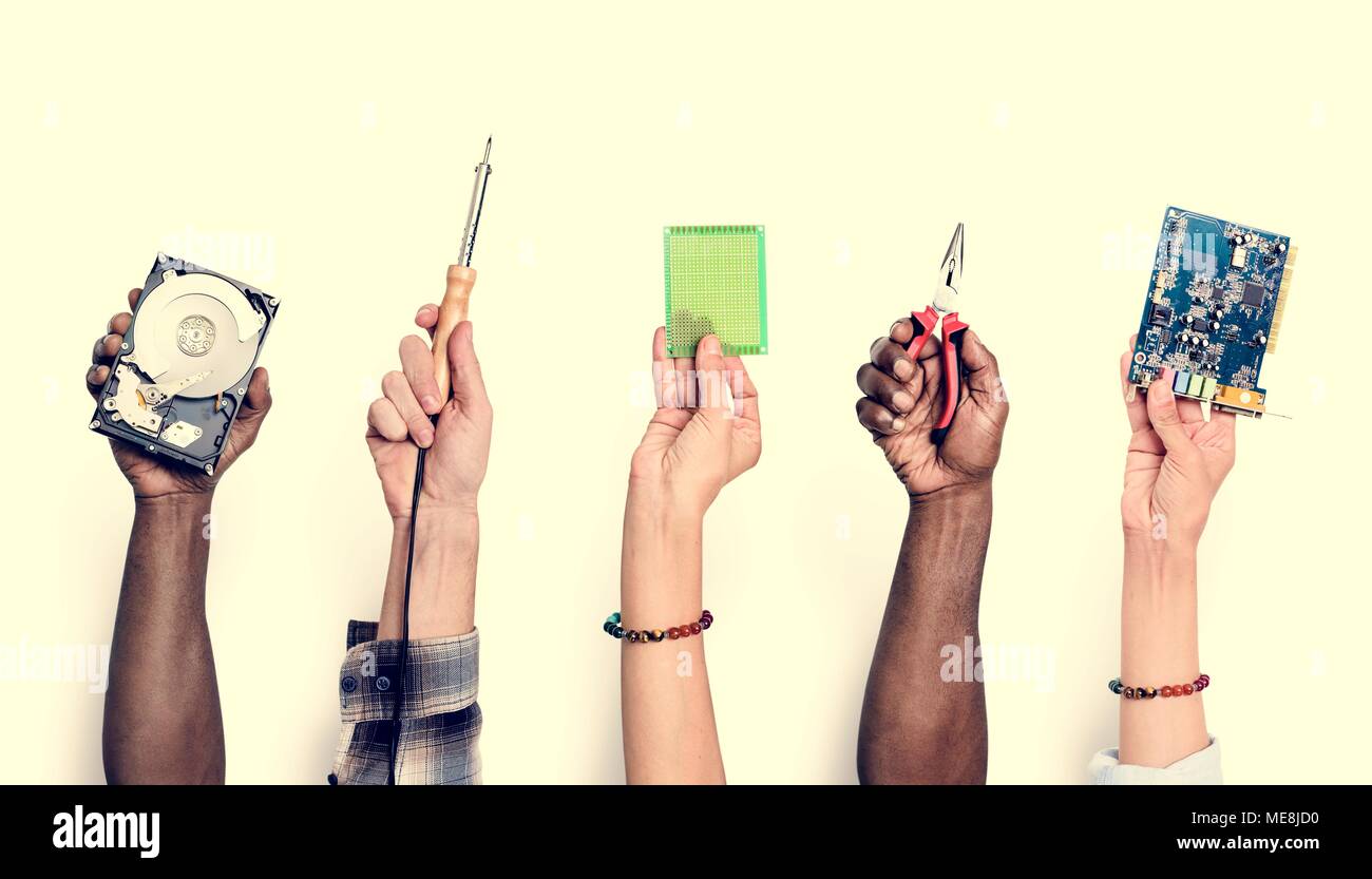 Diverse hands holding computer electronics parts isolated on white Stock Photo