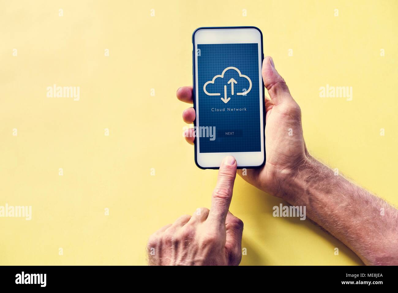 Hands holding a smartphone with cloud network on screen Stock Photo