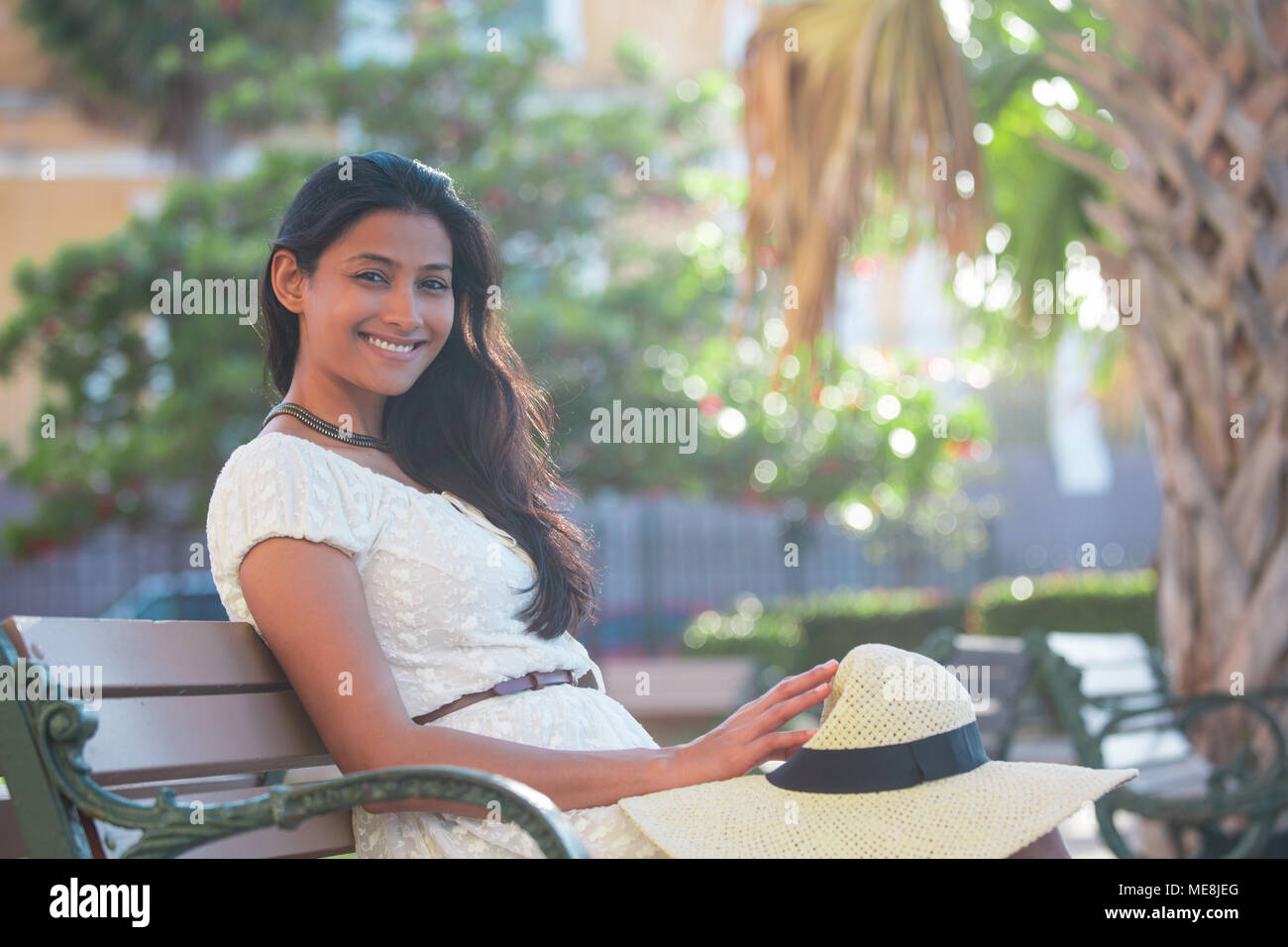 Closeup portrait young beautiful happy woman in white dress, sitting on ...
