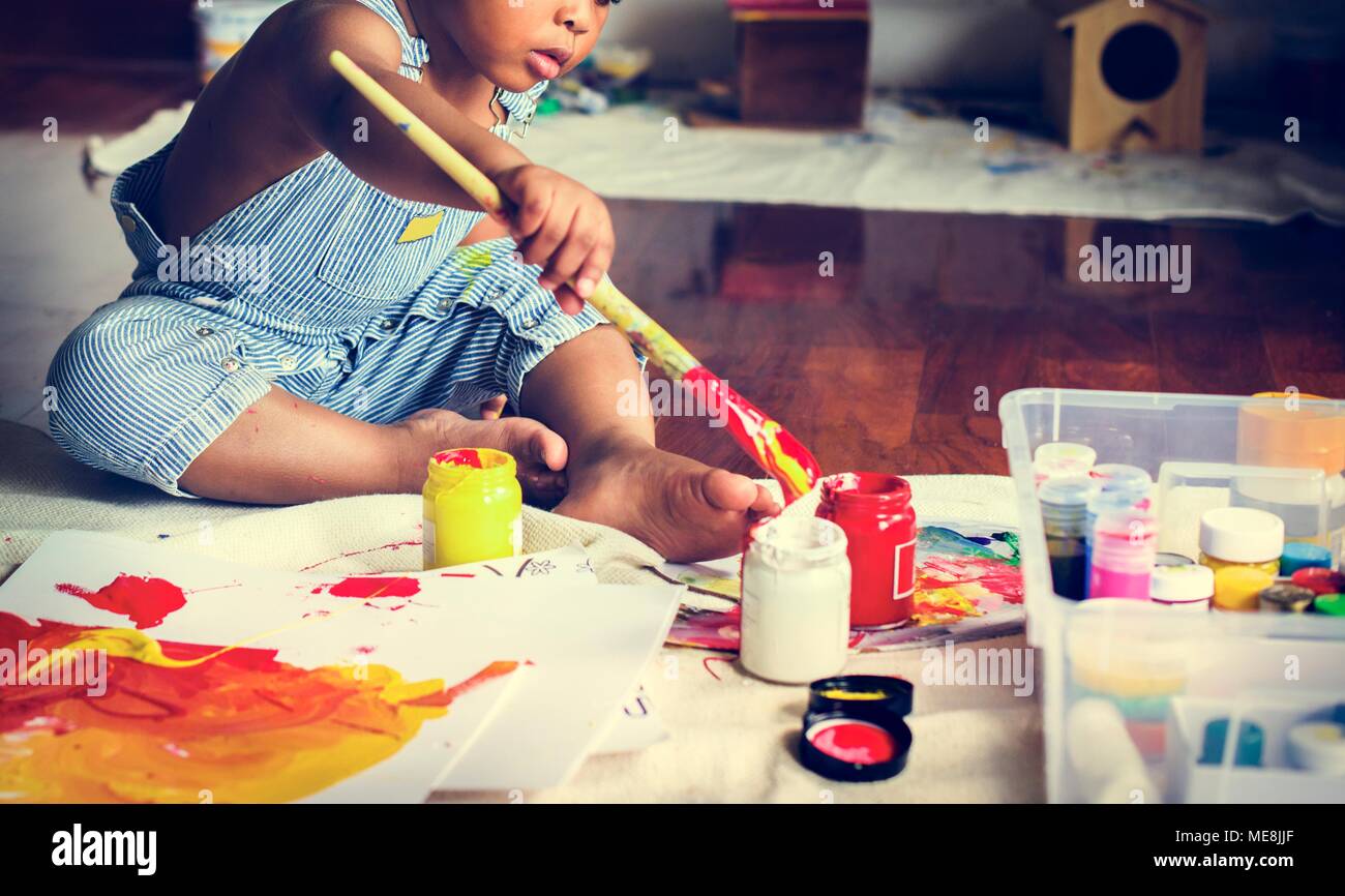 Black kid enjoying his painting Stock Photo