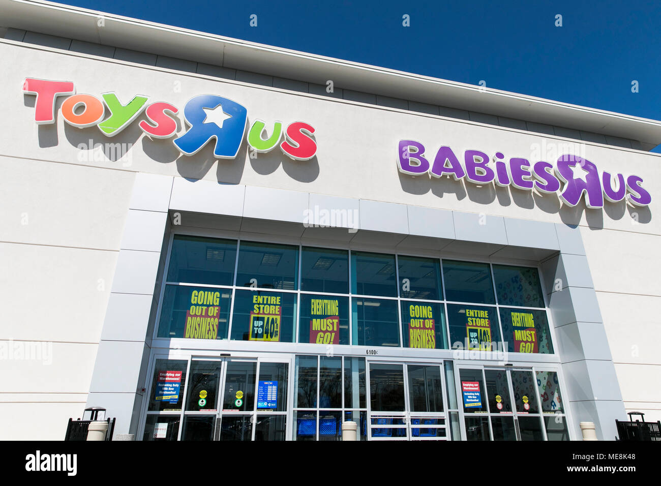 A logo sign outside of a joint Toys 'R' Us and Babies 'R' Us retail store in Columbia, Maryland with 'Going Out Of Business' signage on April 20, 2018 Stock Photo