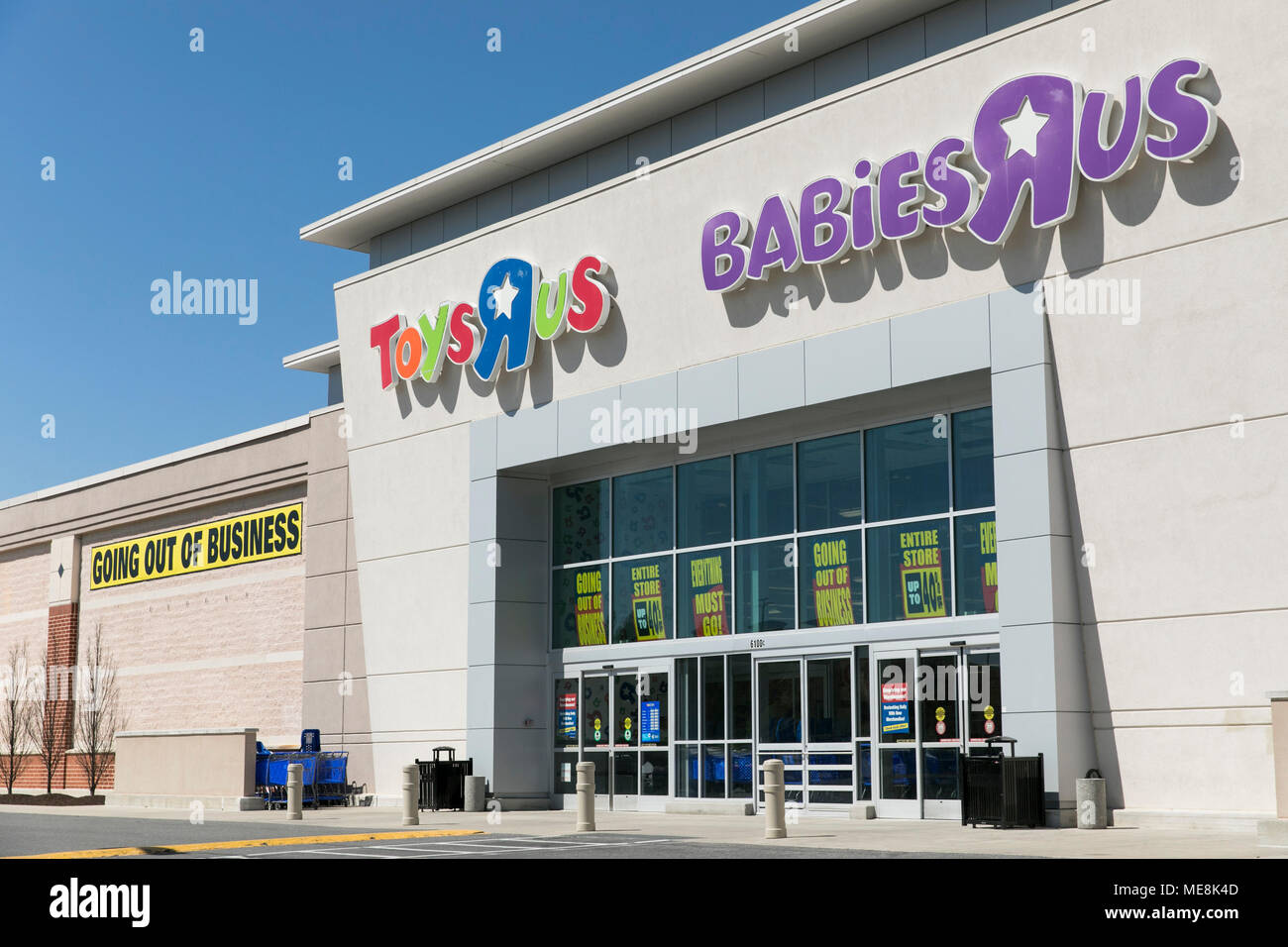 A logo sign outside of a joint Toys 'R' Us and Babies 'R' Us retail store in Columbia, Maryland with 'Going Out Of Business' signage on April 20, 2018 Stock Photo