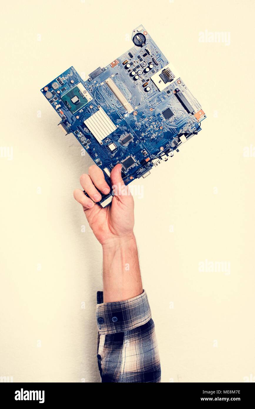 Hand holding motherboard circuit hardware part Stock Photo