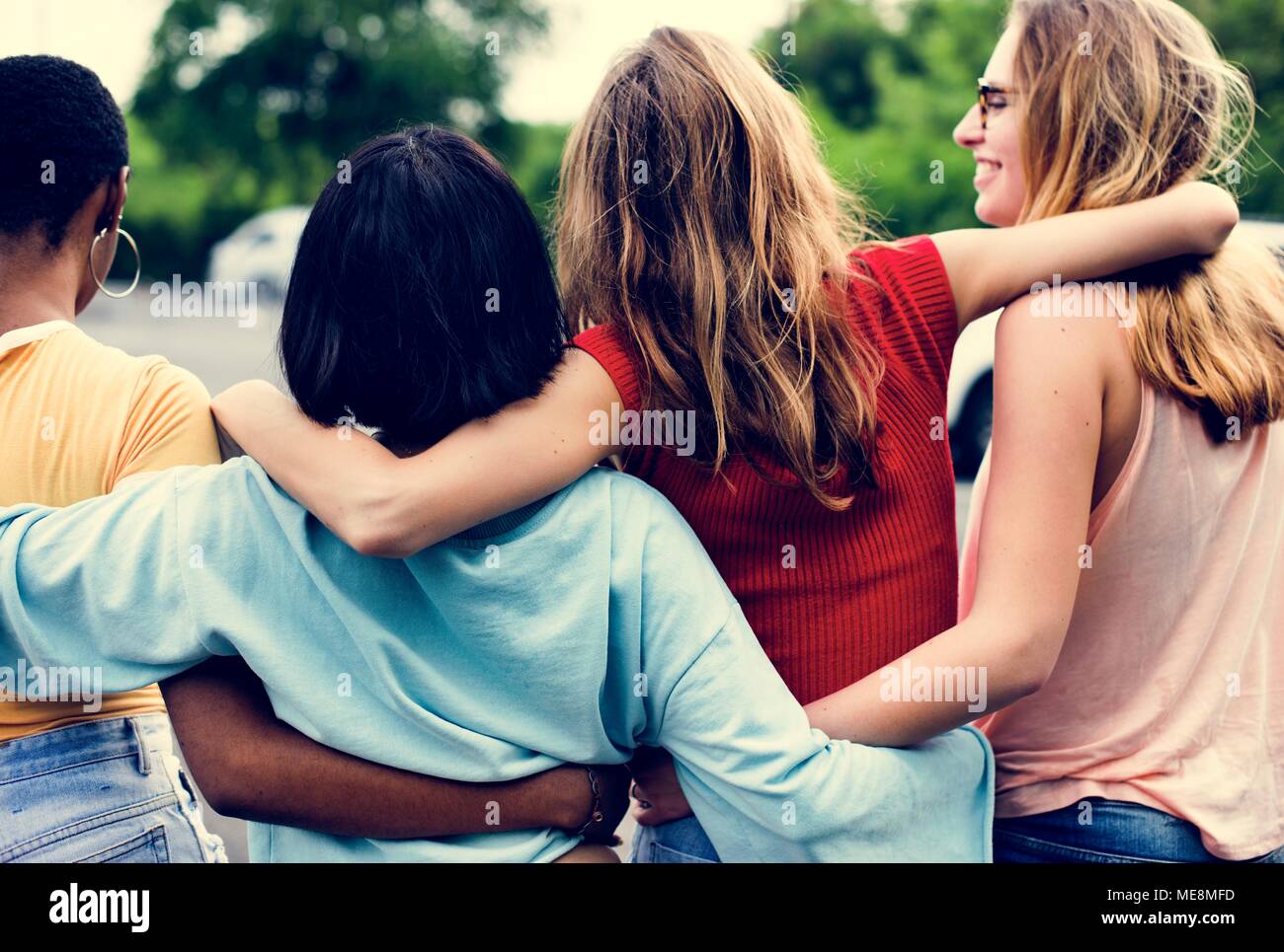 Rear view of a group of diverse woman friends walking together Stock Photo