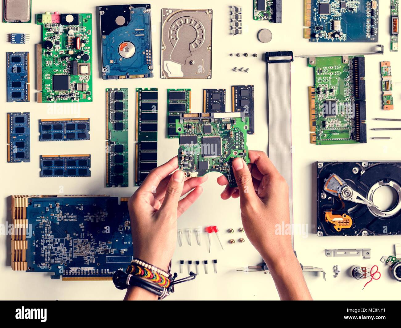 Aerial view of hands with computer electronics parts on white background Stock Photo