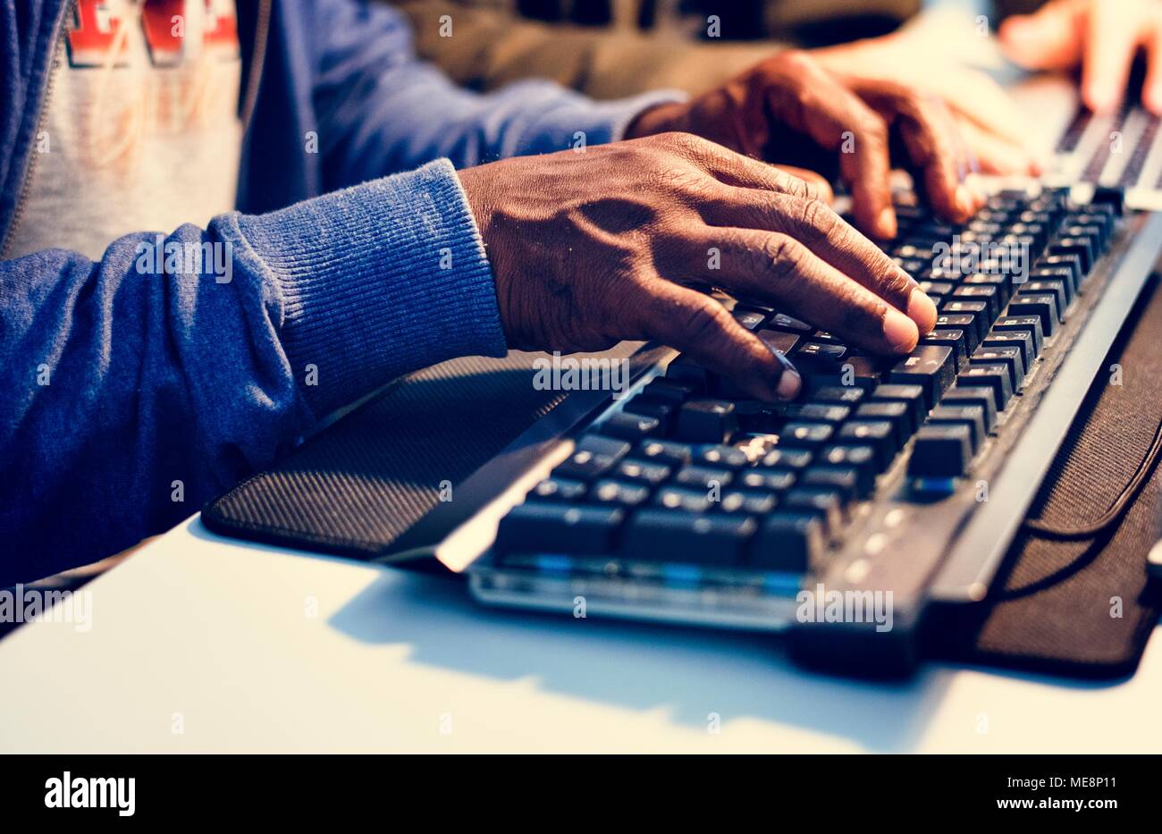 Closeup of hands working on computer keyboard Stock Photo