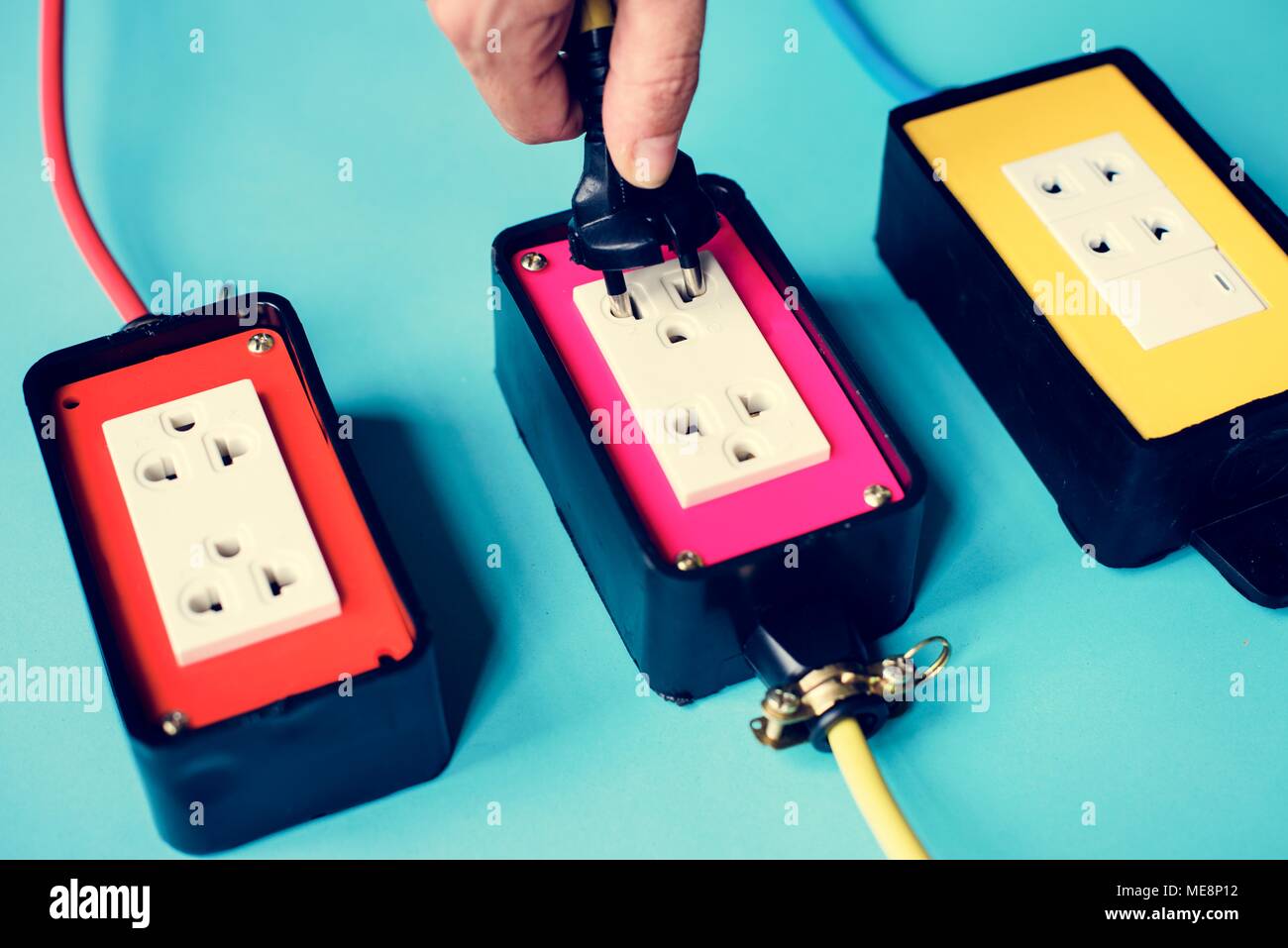 Electrical power supply plugs on blue background Stock Photo