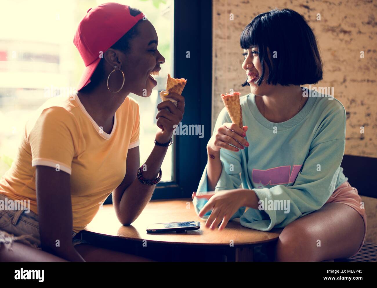 Women eating ice cream together Stock Photo