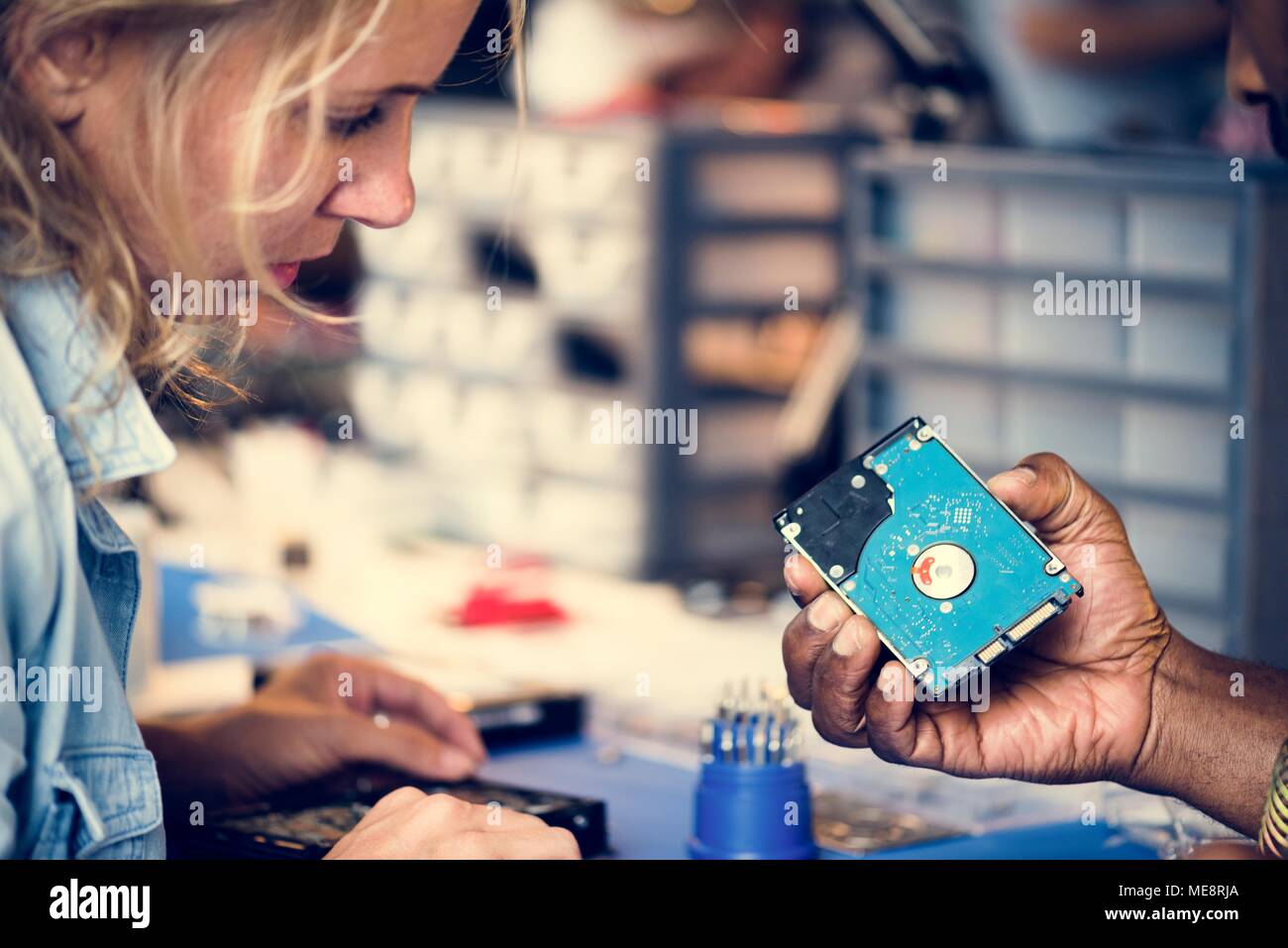 Technicians working on computer hard disk Stock Photo