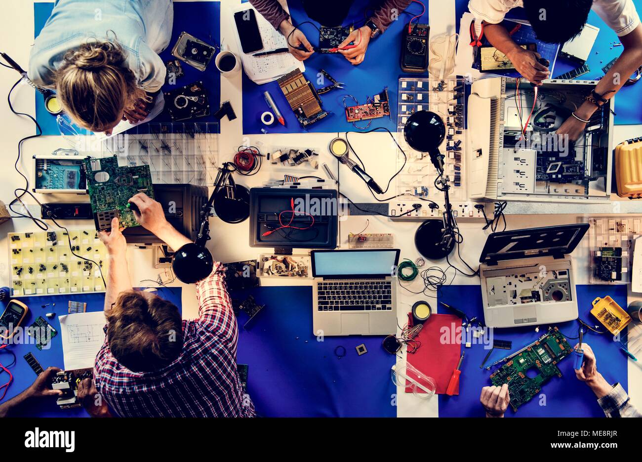 Aerial view of electronics technicians team working Stock Photo