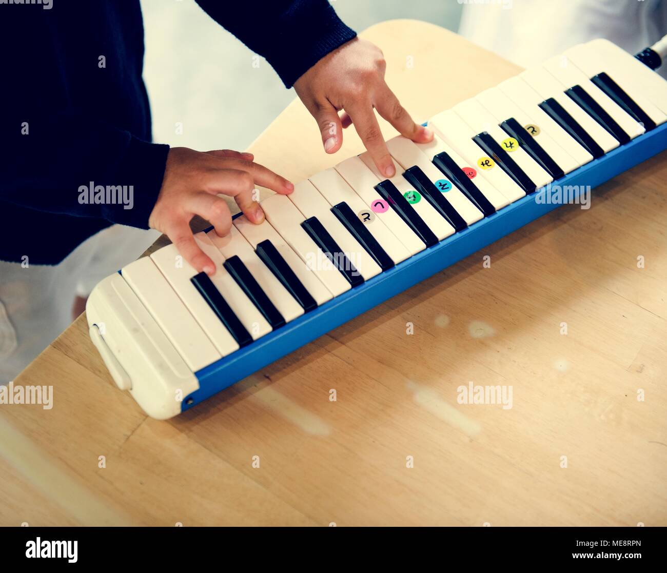 Boy playing piano music toy Stock Photo