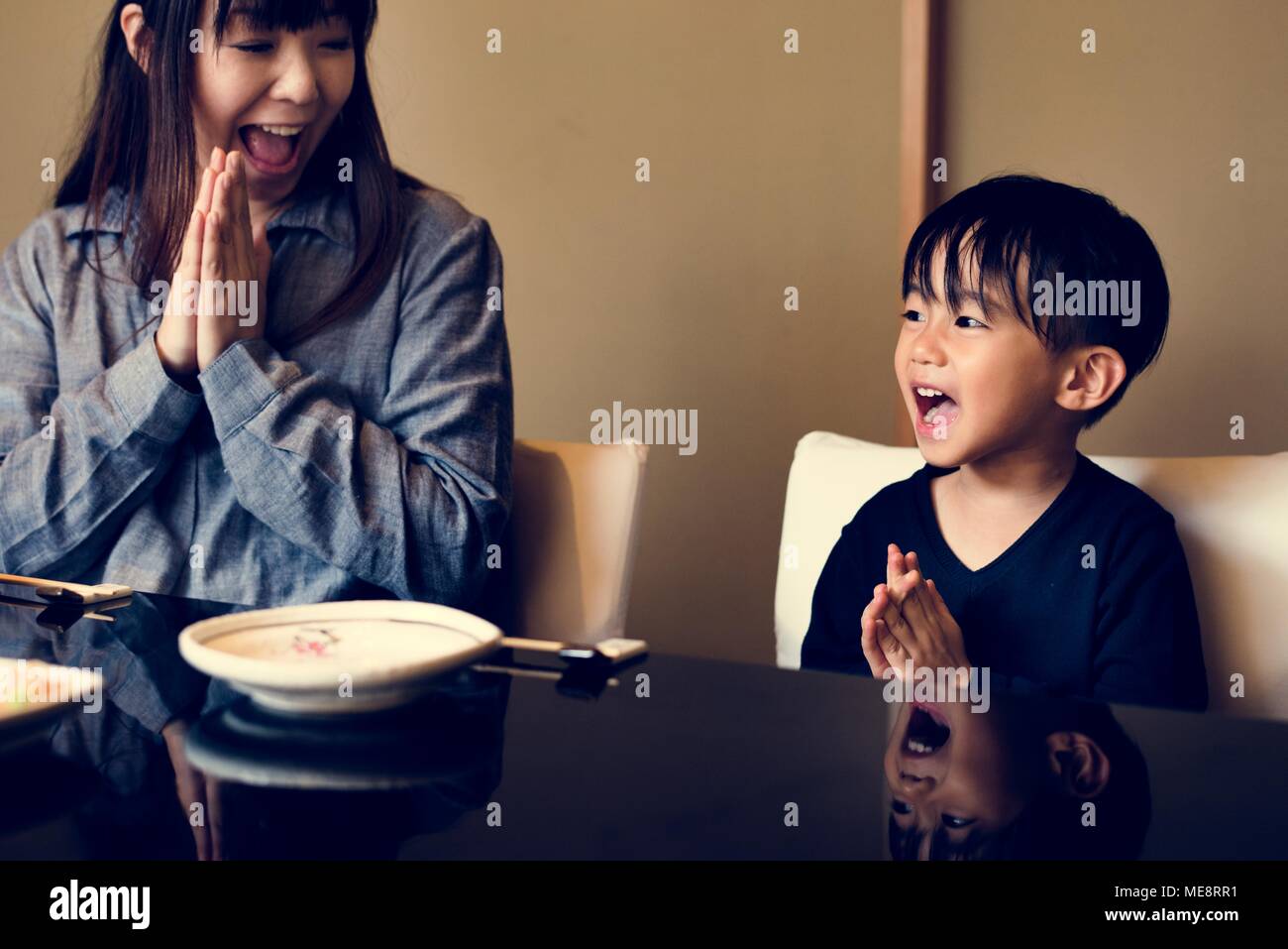 Japanese mother and son praying Stock Photo