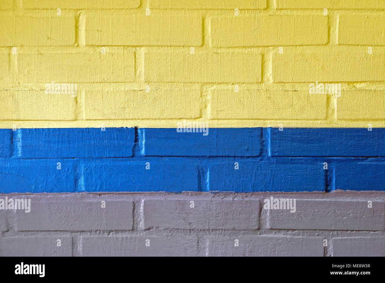 Yellow blue and grey wall made from bricks background Stock Photo Alamy