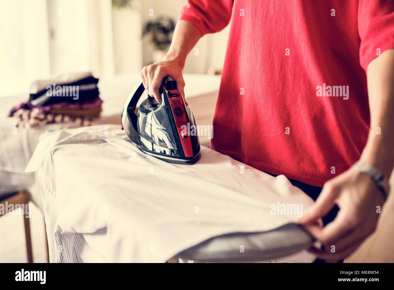 Woman ironing shirt Stock Photo