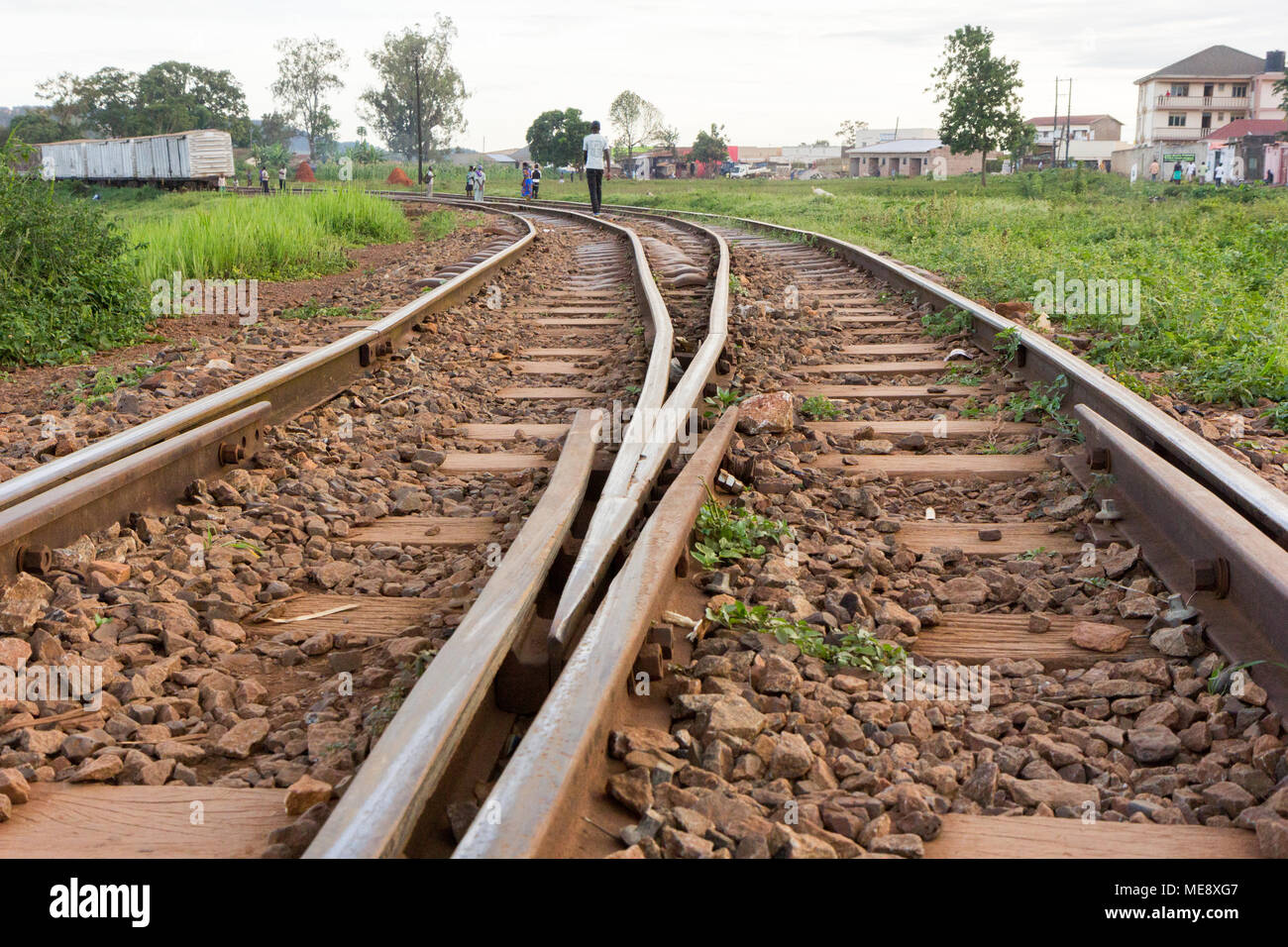 Lugazi, Uganda. 17 May 2017. A railway track in rural Uganda. A man walking along it. Stock Photo