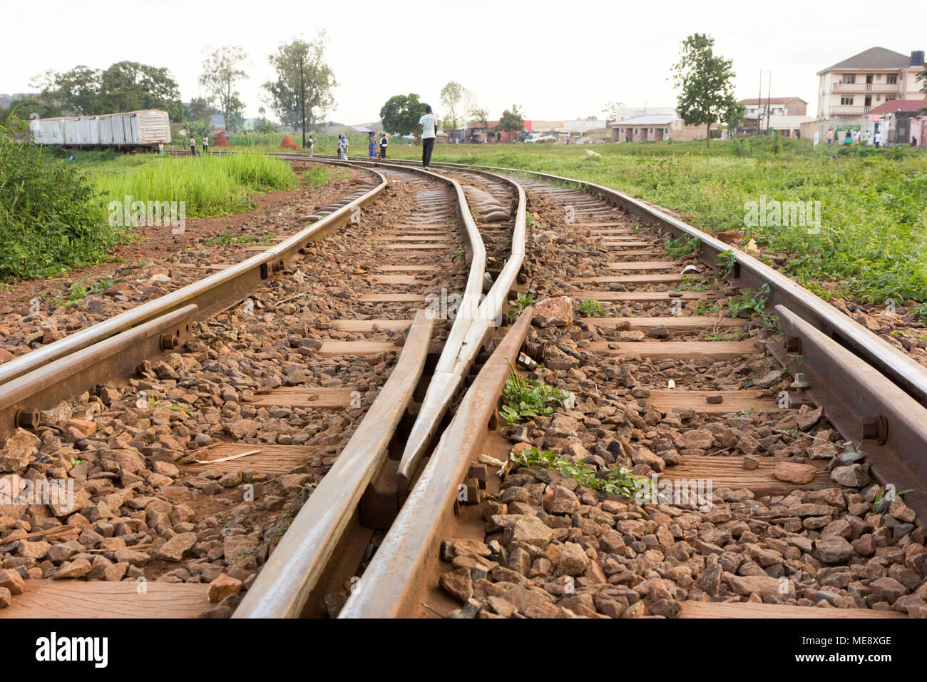 Lugazi, Uganda. 17 May 2017. A railway track in rural Uganda. A man walking along it. Stock Photo