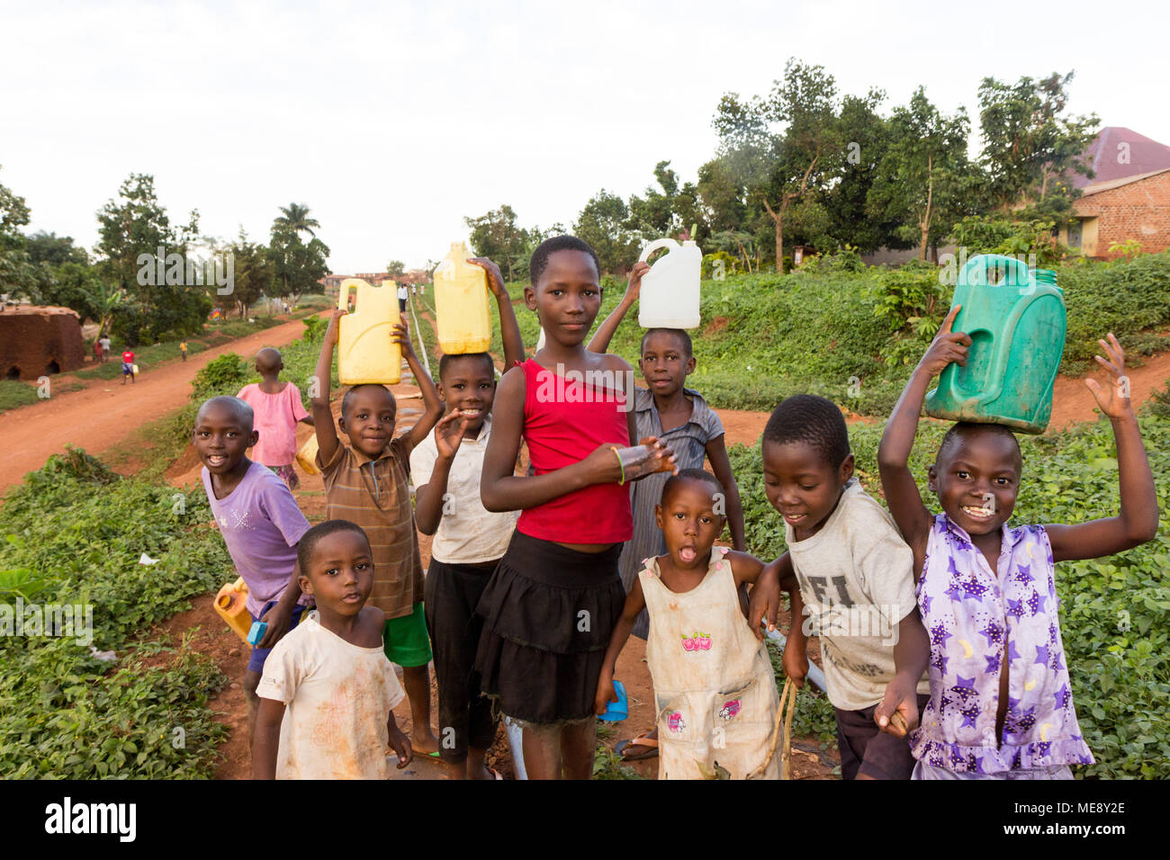 Lugazi, Uganda. 17 May 2017. Smiling Ugandan children running on a railway track in a rural area in Uganda. Stock Photo